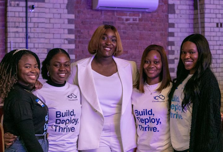 Five team members in Build Deploy Thrive T-shirts