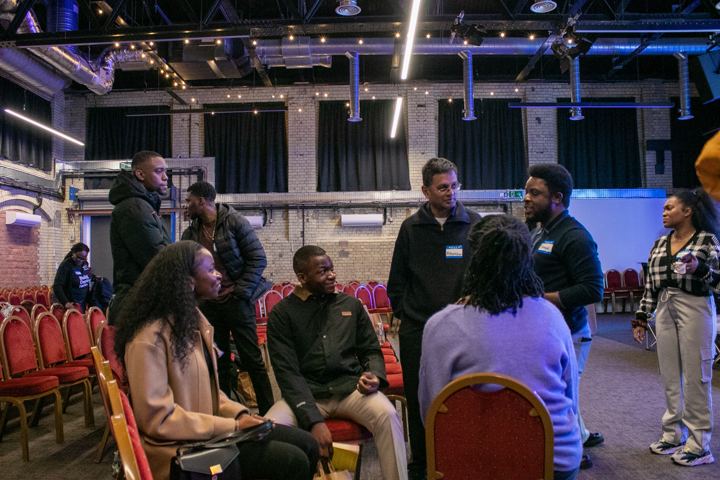 Attendees standing and talking in the venue