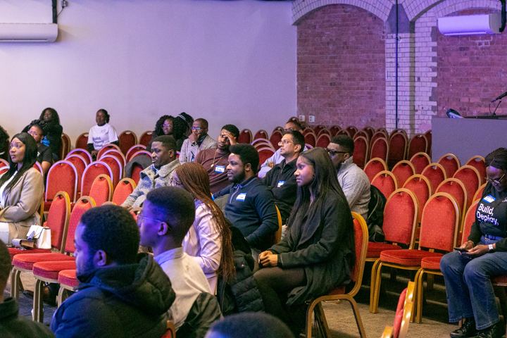 Attendees seated in rows listening to a talk
